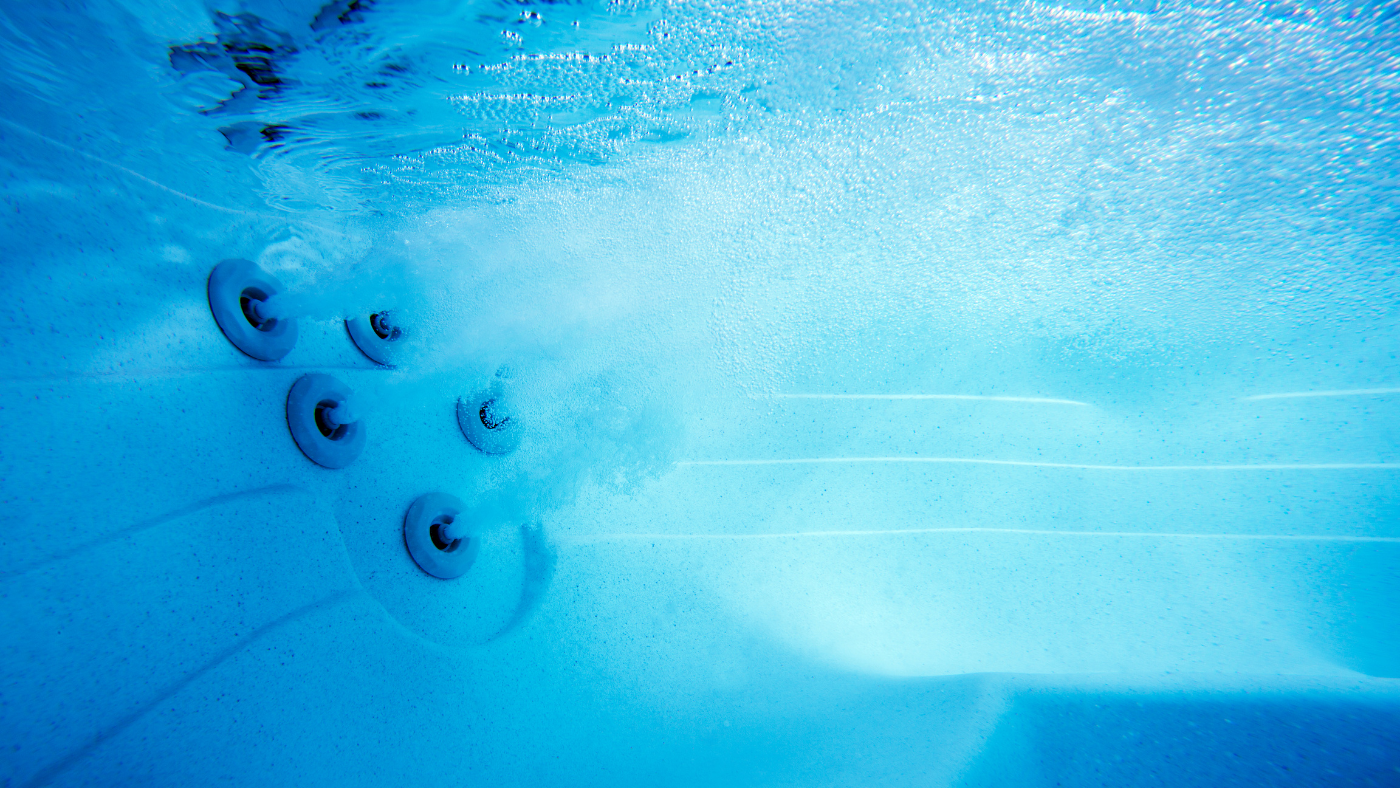 an underwater view of a hot tub with jets actively churning the water